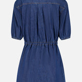 Back view of the Akerman Denim Mini Dress by VERONICA BEARD, featuring short sleeves, a collar, elastic waistband, and knee-length cut, shown on a plain white background.