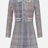The Lauper Tweed-like Mini Dress by VERONICA BEARD features long sleeves, a collar, front buttons, and waist pocket flaps in a purple, white, and rust plaid—perfect for a polished office look.