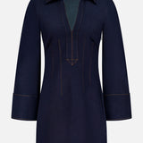 The Raymond Denim Mini Dress by VERONICA BEARD features dark blue denim, a wide collar, deep V-neckline, long sleeves with wide cuffs, tan stitching, and a tailored fit-and-flare silhouette for a timeless style.