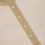 Close-up of the VERONICA BEARD Reynart Contrast Trim Top, featuring a beige ribbed texture and five-button placket. The collar and placket stand out in contrasting tan, making it an ideal base layer with stylish details.