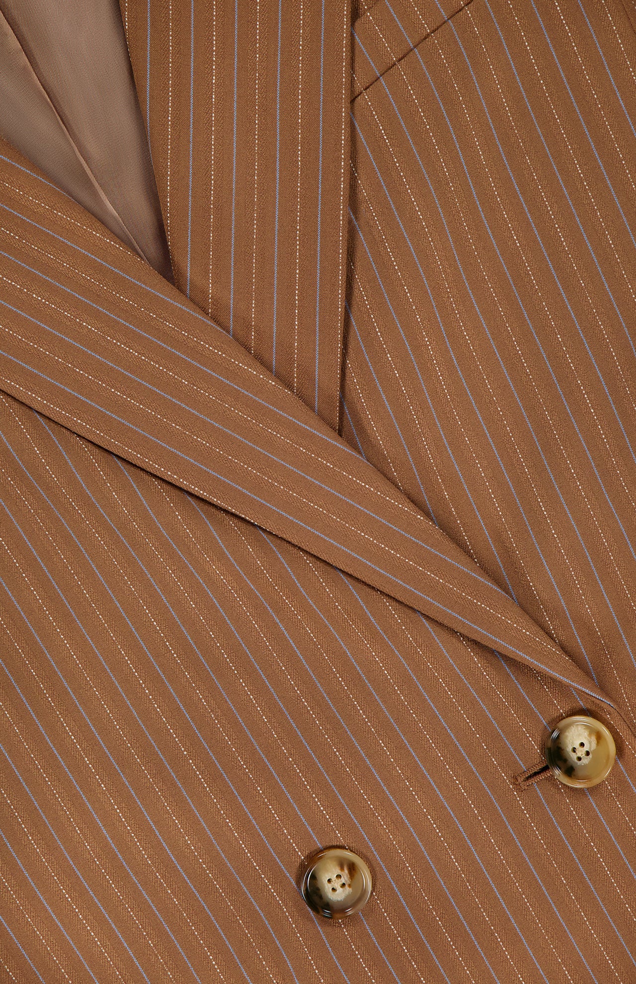 Close-up of the VERONICA BEARD Rupert Oversized Dickey Jacket in brown with light pinstripes, featuring the lapel, part of the collar, and two tan buttons; this blazer is dickey compatible for versatile styling.