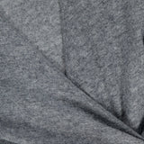 Close-up of the Salomez Knit Wrap Dress by VERONICA BEARD in soft heather gray merino wool, highlighting the fabric's texture, visible stitching, and a gentle fold at the hem.