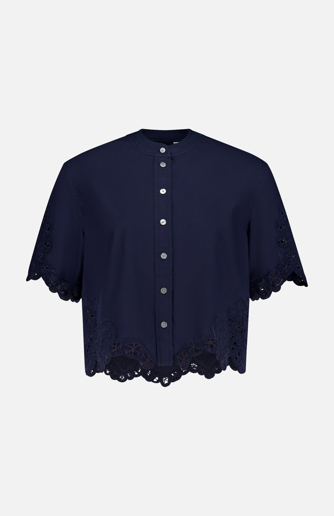 The Aleck Scalloped Embroidery Shirt by VERONICA BEARD is a navy, cotton poplin blouse with short sleeves, a button-down front, scalloped lace embroidery at the hem and sleeves, and decorative cut-out details. Displayed on a white background.