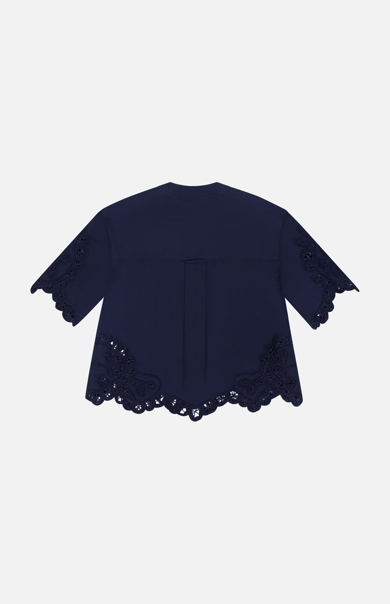 The Aleck Scalloped Embroidery Shirt by VERONICA BEARD in navy cotton poplin features short sleeves, floral scalloped lace embroidery on the sleeves and hem, and is shown from the back against a white background.