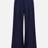The VERONICA BEARD Allman Wide Leg Button Tab Pant features a high waist, front pleats, belt loops, and button accents at the waistband. These versatile navy women’s cotton pants are showcased against a plain white background.