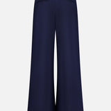 The VERONICA BEARD Allman Wide Leg Button Tab Pant is a women’s navy cotton pant with a high waist and two back welt pockets, shown against a white background.