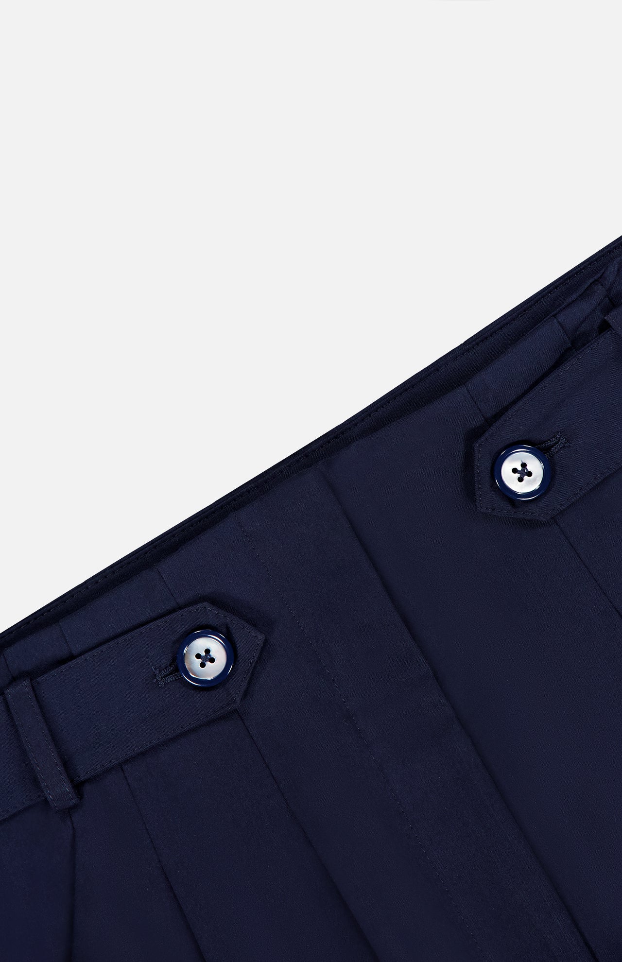 Close-up of the waistband on the VERONICA BEARD Allman Wide Leg Button Tab Pant, showing two belt loops with dark buttons and detailed stitching, set against a plain light background.
