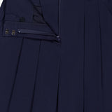 Close-up of VERONICA BEARD's Allman Wide Leg Button Tab Pant in navy cotton, showcasing the neatly pressed waistband, pleats, button tab, zipper, and metal hook-and-bar closures with partial unfastening to highlight refined details.