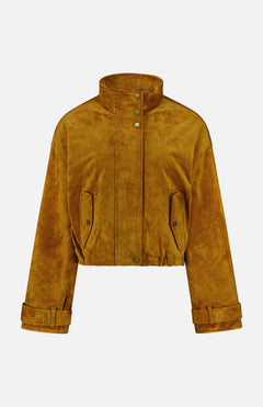 The Bateman Cropped Suede Jacket by VERONICA BEARD is a mustard yellow suede piece with a high funnel neck collar, snap buttons, flap pockets, and cuffed long sleeves—an ideal choice for stylish fall outerwear—shown against a plain white background.