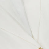 Close-up of the VERONICA BEARD Battista Dickey Jacket, a white blazer featuring a smooth, tailored finish, classic lapel, buttonhole detail, and a single beige button.