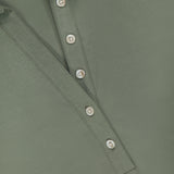 A close-up of the VERONICA BEARD Besser Ruched Polo Dress in olive green micro-rib stretch cotton, featuring a partially unbuttoned placket with four white buttons, highlighting the fabric texture and stitching details.