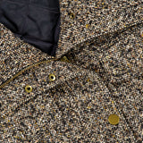 Close-up of the Tweed Butler Dickey Jacket by VERONICA BEARD, featuring textured brown tweed, gold snap buttons, a zipper, and quilted black lining. This ladylike jacket is dickey compatible for versatile styling options in your wardrobe.