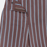 The Carraway Pant by VERONICA BEARD features a brown wide-leg design with vertical white and blue stripes, a high-rise waistband with button, hook, and zip closure, and lightweight textured fabric for added style.