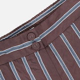 Close-up of VERONICA BEARD Carraway Pant—brown with textured vertical white and blue stripes, featuring an elastic waistband and two brown buttons.