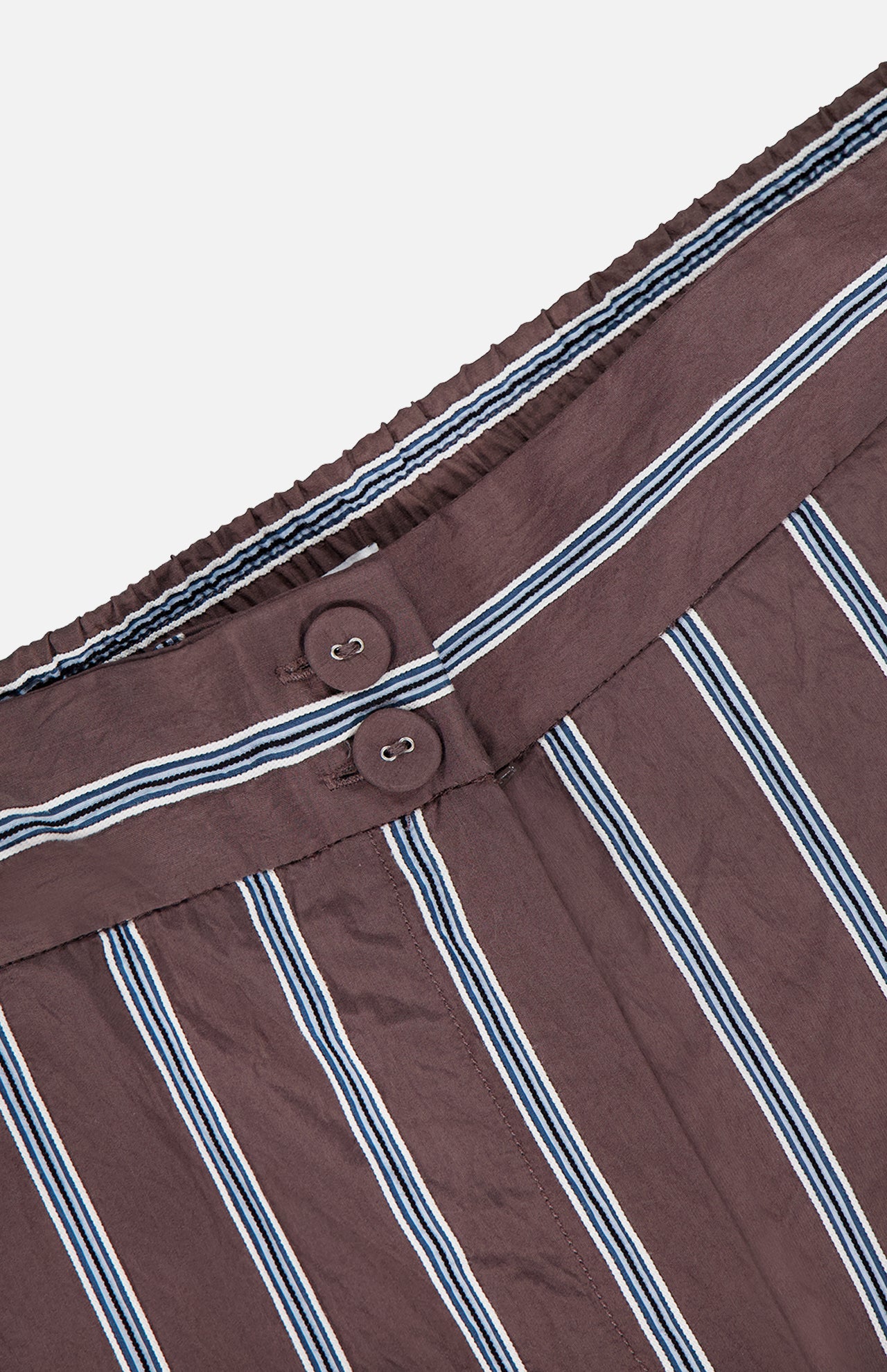 Close-up of VERONICA BEARD Carraway Pant—brown with textured vertical white and blue stripes, featuring an elastic waistband and two brown buttons.