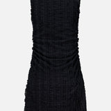 The Charissa Ruched Mini Dress by VERONICA BEARD is a sleeveless black mini dress featuring a subtle plaid texture, shown from the back. Designed with gathered ruching along the sides, this body-sculpting dress offers a slightly fitted silhouette against a plain light gray background.