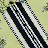 Close-up of the Clean Spruce Cropped Top by VERONICA BEARD: light green, cropped, with black buttons, floral designs on the collar and parts, plus black and white vertical stripes. Brand label is visible inside the collar.