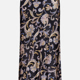 The VERONICA BEARD Clover Paisley Midi Skirt is a 90s-inspired black satin slip skirt with a gold, lilac, and beige paisley floral pattern, shown against a plain white background.