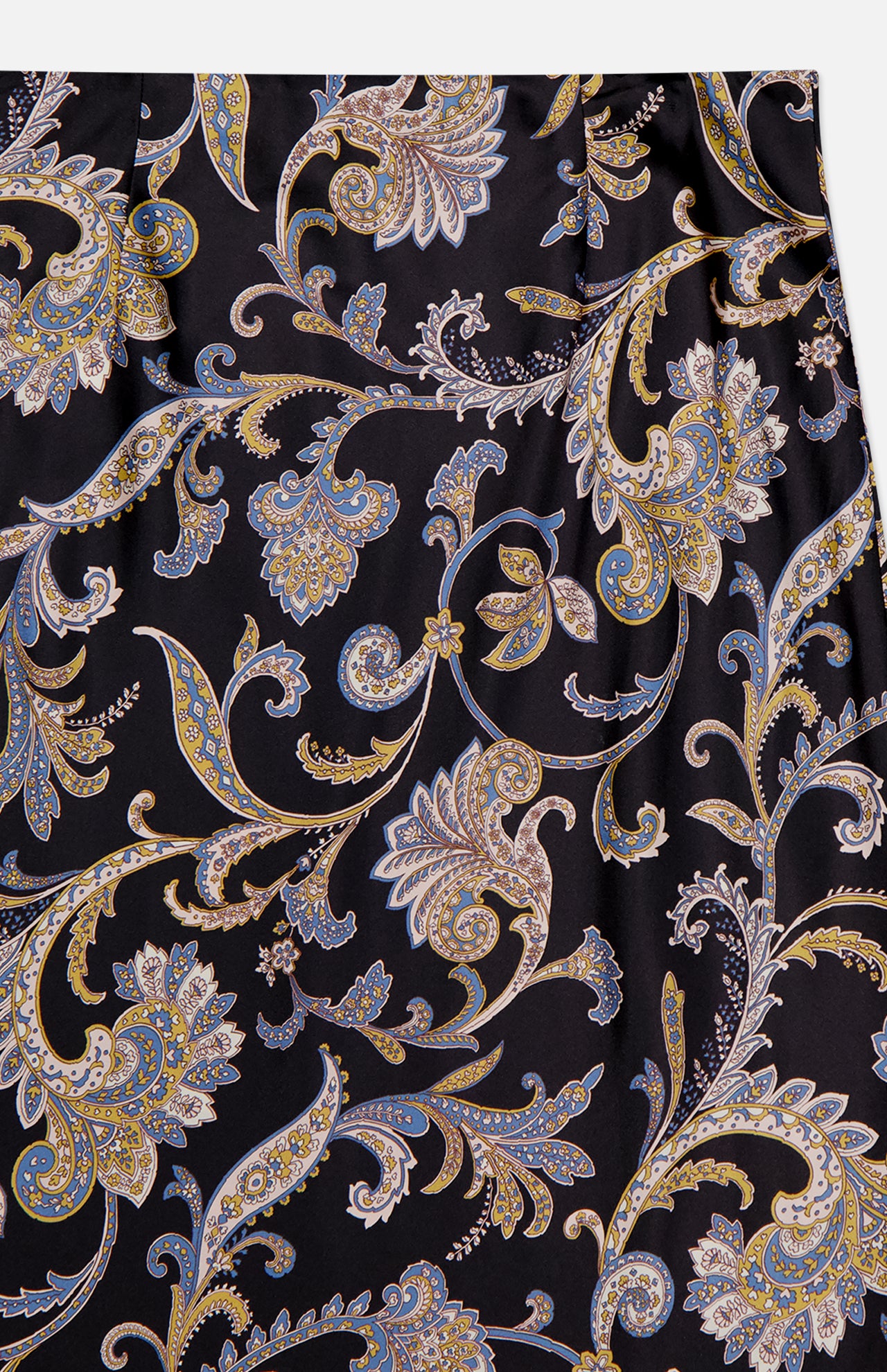 A close-up of the VERONICA BEARD Clover Paisley Midi Skirt, featuring an ornate gold, blue, and beige paisley pattern with swirling leaves and floral motifs on a black background.