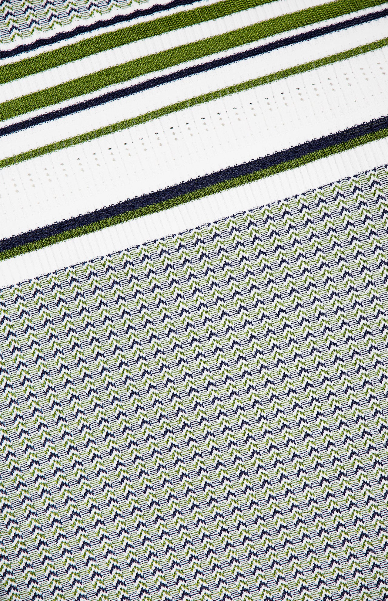 The Dawna Knit Midi Dress by VERONICA BEARD features a geometric, repetitive variegated stripe design in navy blue, green, and white with zigzag patterns and bold horizontal stripes at the top.