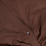 A close-up of the VERONICA BEARD Devra Short Sleeve Ruched Top in brown stretch cotton poplin with button details and waist-defining ruching, labeled VERONICA BEARD, size 2.