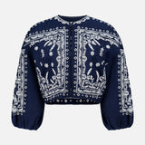 The Drake Embroidered Balloon Sleeve Jacket by VERONICA BEARD is a navy blue cropped blouse with white paisley and floral bandana-style embroidery, round neckline, and loose, gathered balloon sleeves.