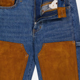 A pair of VERONICA BEARD Dylan High Rise Straight Leg Jeans in blue denim, featuring brown suede patches and trim, partially unzipped to show the inner white pocket lining, with the brand label visible on the waistband.