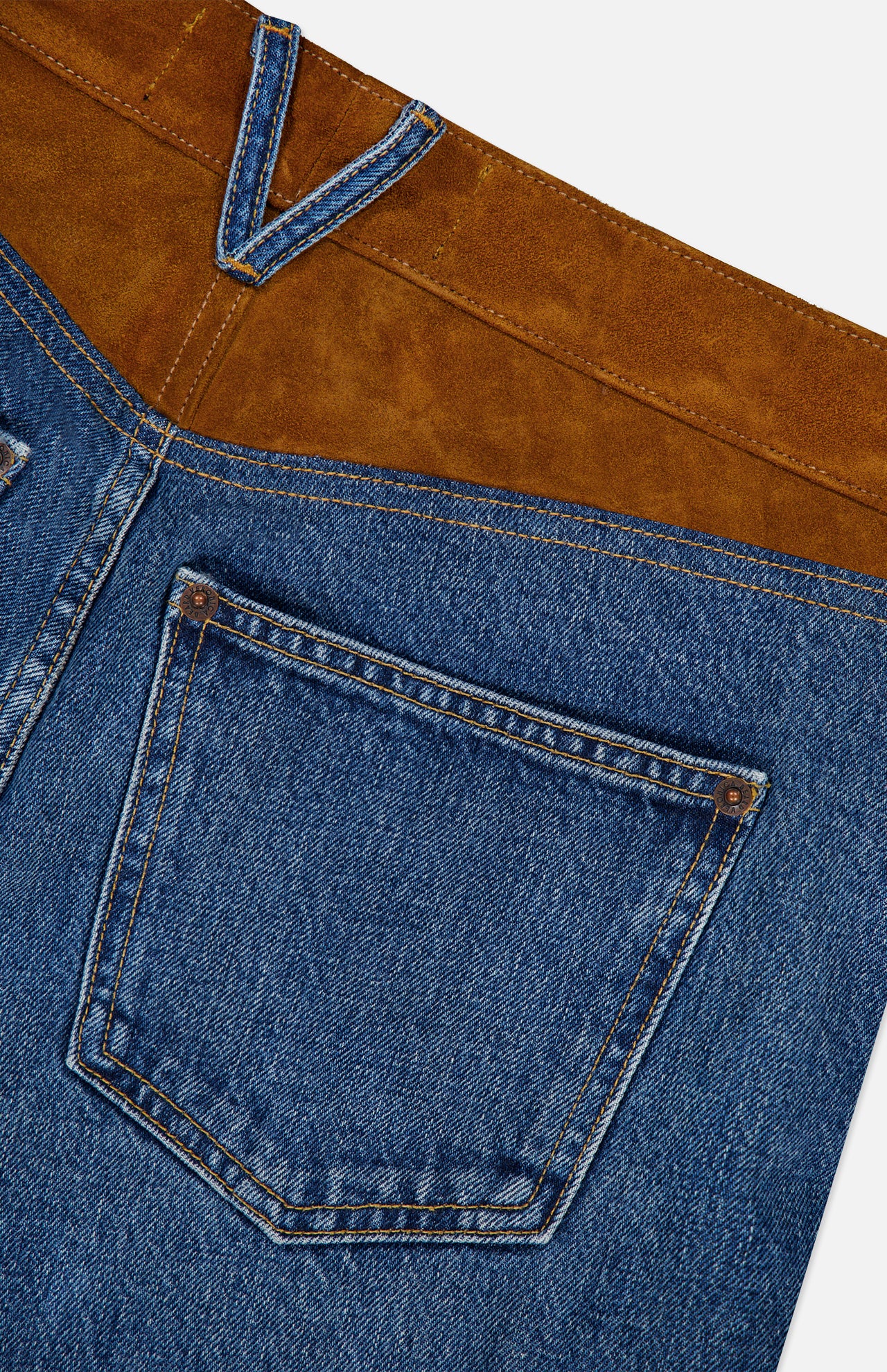 Close-up of the Dylan High Rise Straight Leg Jean by VERONICA BEARD, crafted in the USA with a brown suede yoke, a single back pocket, detailed stitching, and contrasting suede panels.