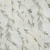 Close-up of the Emiko Floral and Lace Blouse by VERONICA BEARD, crafted in cotton-silk voile with a pastel prairie floral print, white buttons, and lace trim along the button placket.
