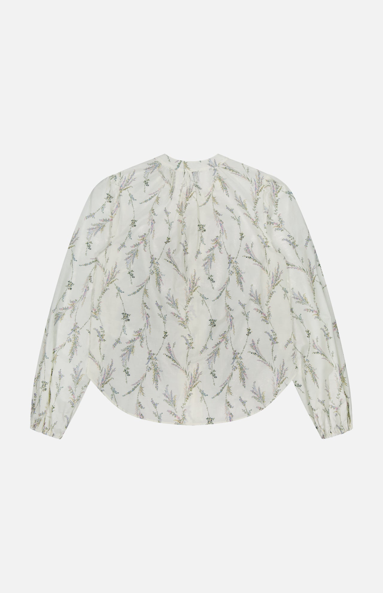 The Emiko Floral and Lace Blouse by VERONICA BEARD is a sheer, long-sleeved ivory cotton-silk voile top with a loose fit, subtle prairie floral motif, gathered cuffs, and a rounded hem. Shown flat on a white background.