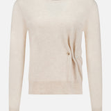 The Frankie Pearl Pin Pullover Sweater by VERONICA BEARD is a long-sleeved, light beige neutral sweater with a round neckline. Crafted from soft merino wool, it features a subtle ribbed hem and cuffs, along with a distinctive small pearl pin detail on the right side near the waist, offering both comfort and timeless elegance.