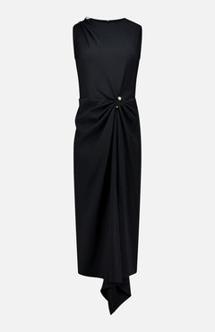 The Freja Pearl Brooch Dress by VERONICA BEARD is a sleeveless black dress featuring an asymmetrical hem and draped fabric gathered at the waist by two metallic buttons, displayed on a plain white background.