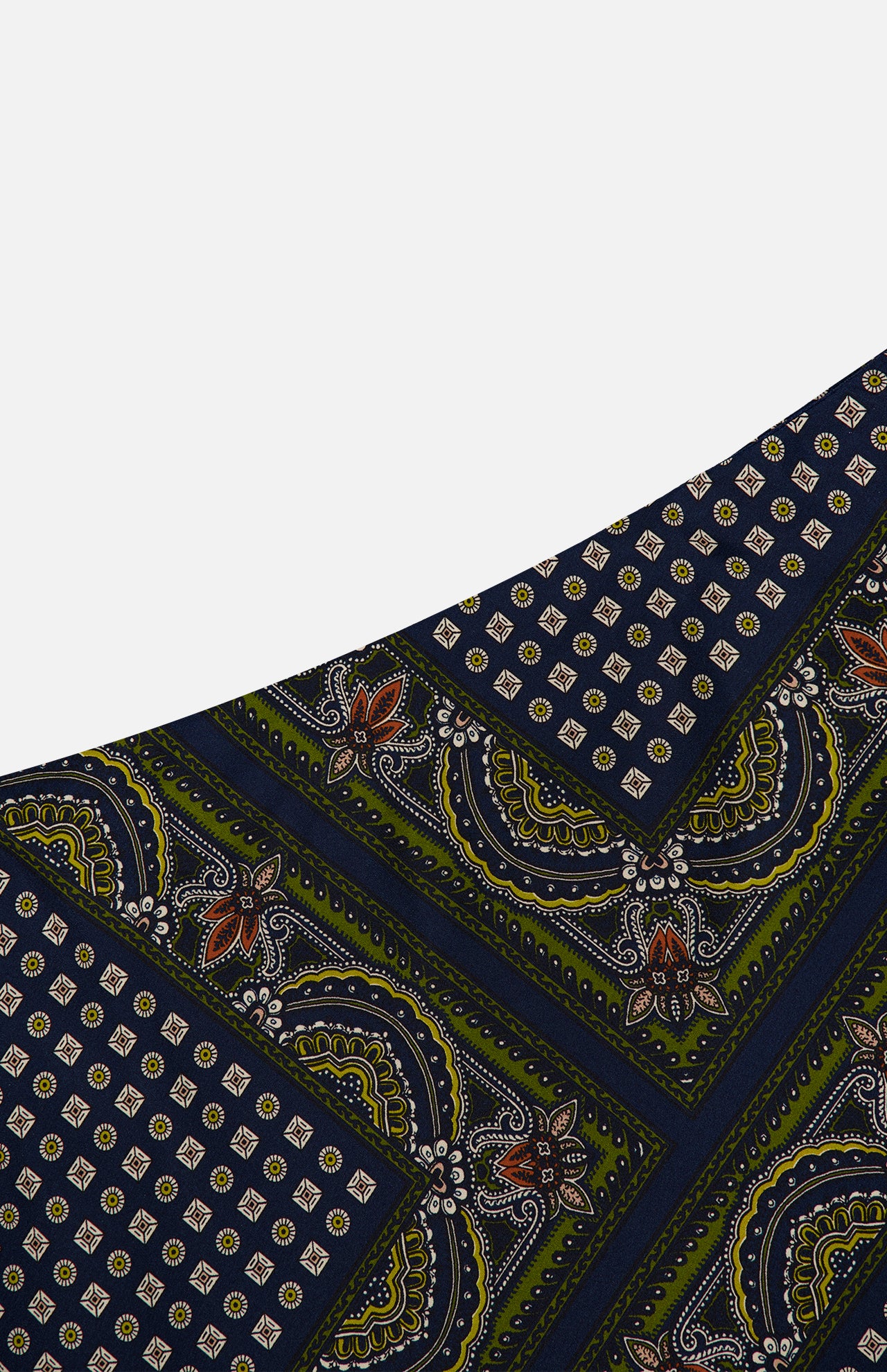 A close-up of the Hartley Scarf Print Skirt by VERONICA BEARD showcases its navy blue fabric adorned with green, white, and rust floral and geometric motifs arranged diagonally—ideal for creating a striking statement piece or styling as an elegant silk midi skirt.