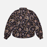 The VERONICA BEARD Silk Hickory Blouse is a long-sleeved silk georgette top with a high neck and ruffled cuffs, showcasing an ornate gold, lilac, and brown floral paisley pattern on a dark background.