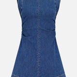 The Imara Denim Mini Dress by VERONICA BEARD is a sleeveless, tailored dark blue mini dress with a round neckline, fitted bodice, subtle waist ruching, and an A-line skirt, shown against a white background.