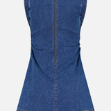 The Imara Denim Mini Dress by VERONICA BEARD is a sleeveless dark blue mini dress, shown from the back with a central visible zipper and subtle seam and hem stitching for a tailored finish.