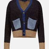 The Josiane Cardigan Sweater by VERONICA BEARD is a cropped, long-sleeve piece from our latest knitwear collection, designed with a relaxed cardigan fit. It features a dark brown body accented with blue trim and pockets, colorblock sweater details including contrasting brown cuffs and waistband, and is finished with three black buttons down the front.
