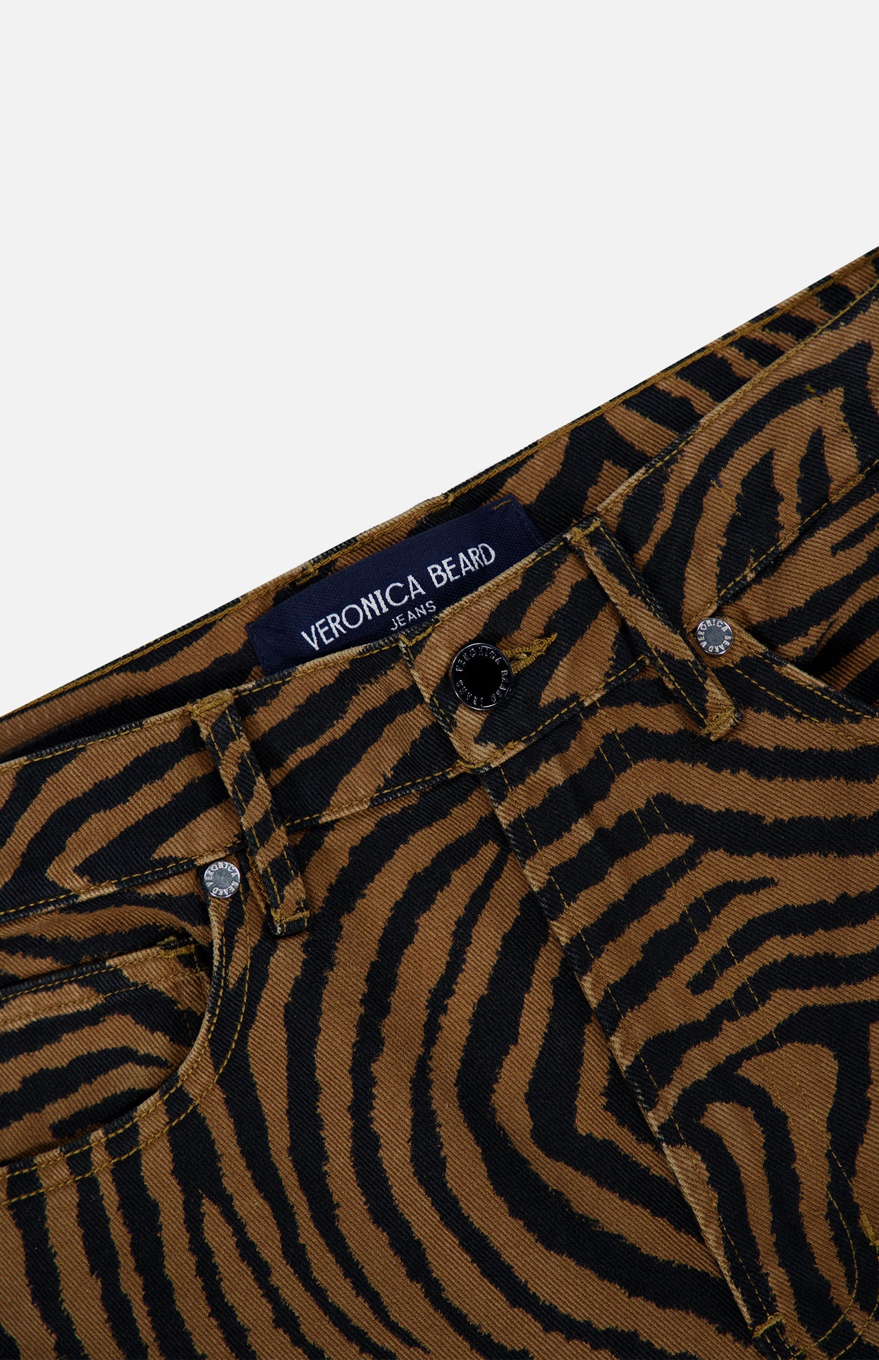 Close-up of the waistband and button fly of brown and black zebra-print Kasey Ziger Print Pant jeans.