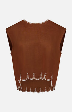 The Kessan Embroidered Linen Top by VERONICA BEARD features a sleeveless, brown design with white scalloped edges, decorative loops, and a straight neckline. Its lightweight, slightly sheer linen is perfect for warm days.