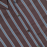 Close-up of the VERONICA BEARD Lloyd Striped Button Down Shirt, showcasing brown fabric with white and blue vertical stripes, a visible collar, and relaxed fit.