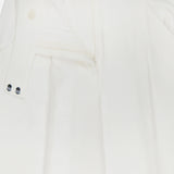 Close-up of the VERONICA BEARD Marbeau Wide Leg Pant in off-white, featuring a high-rise waist, partially unzipped and unbuttoned front, double button tab, and pleated details.