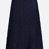 The VERONICA BEARD Massimo Stretch Midi Skirt features a navy, knee-length A-line cut in crinkled fabric—ideal for office to evening wear—shown on a plain white background.