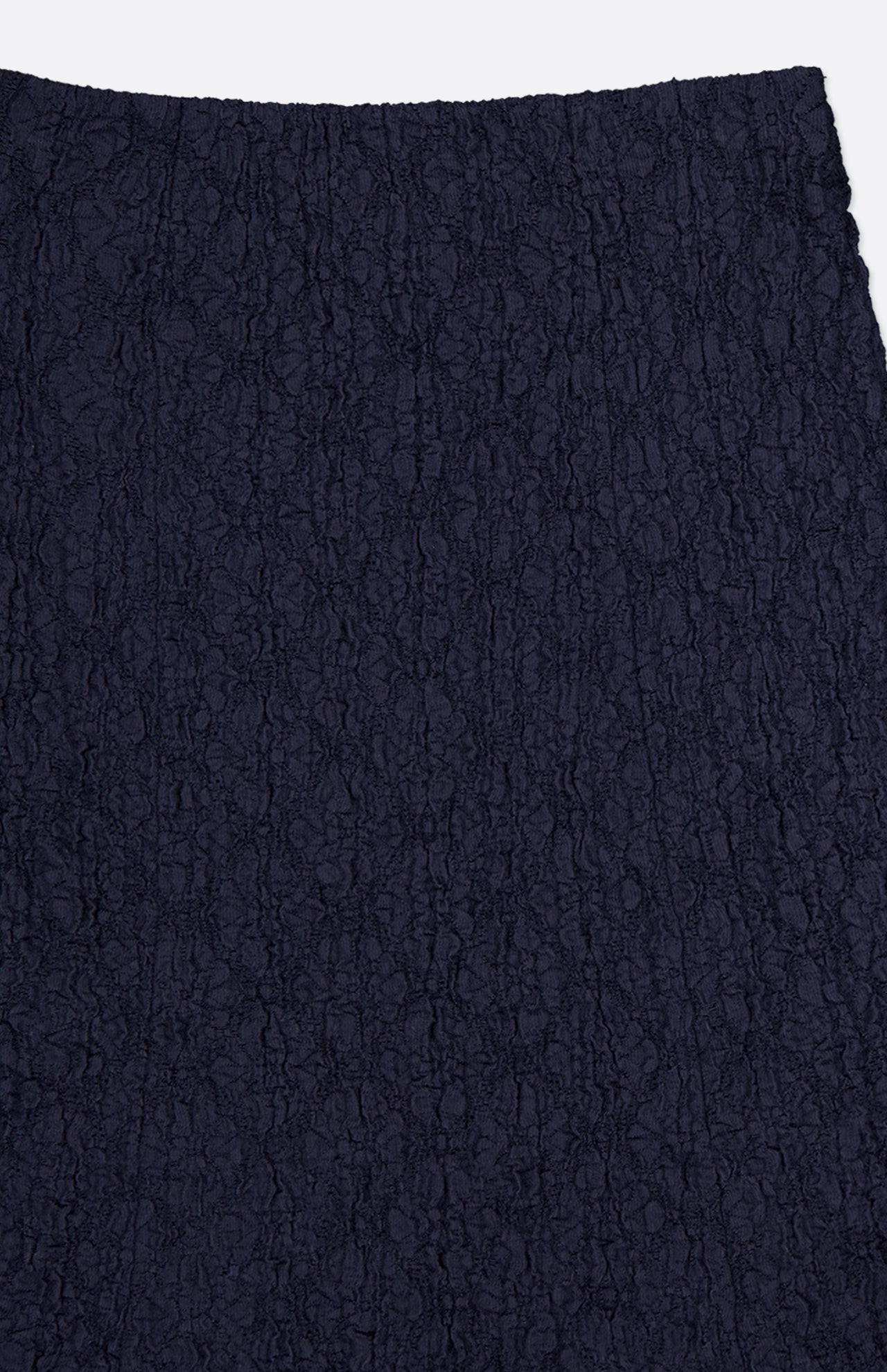 Close-up of the VERONICA BEARD Massimo Stretch Midi Skirt in dark navy, showcasing its intricate vertical lace pattern and textured fabric against a plain white background.