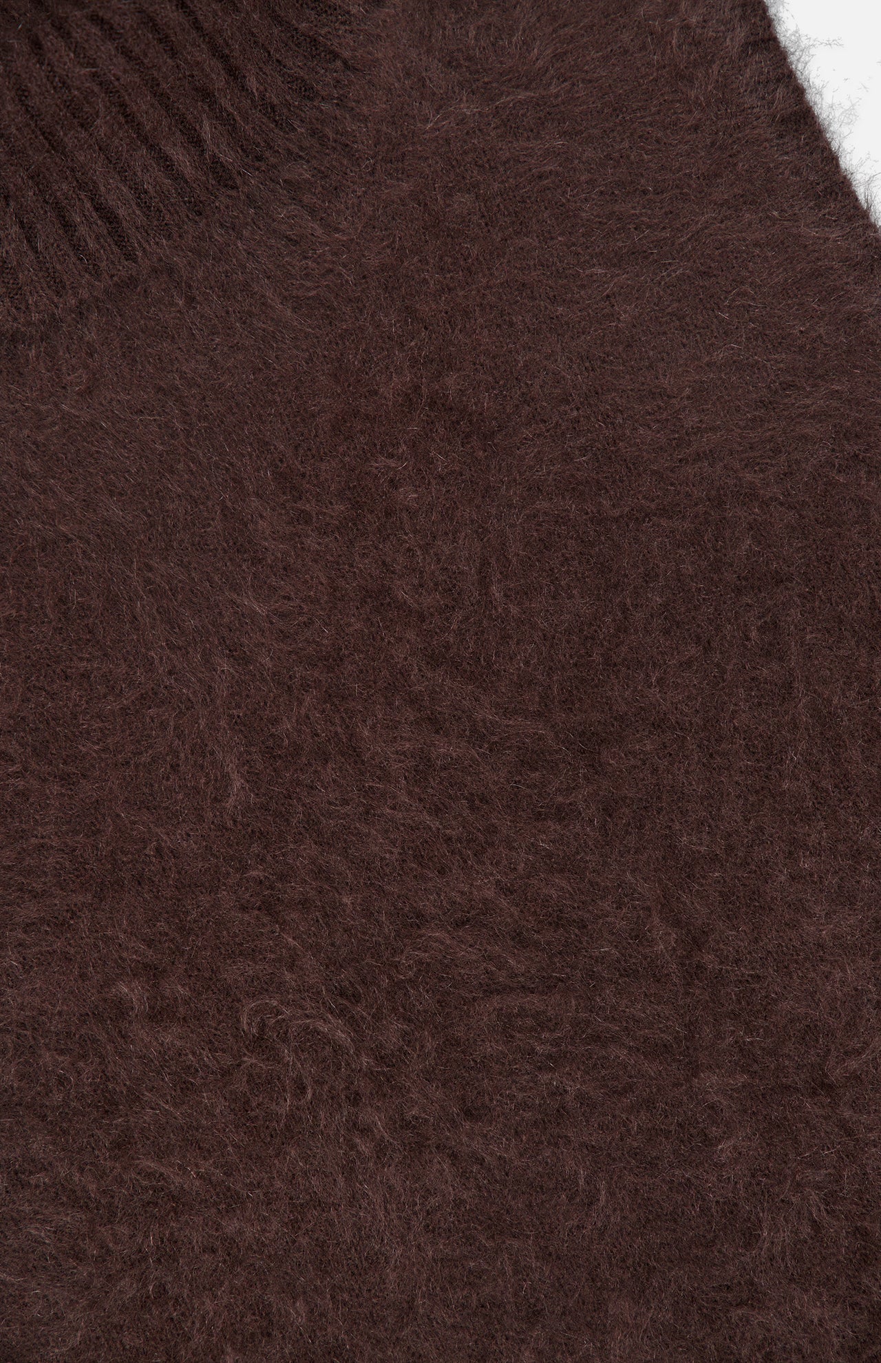 Close-up of the Mazzy Brushed Cashmere Shell Top by VERONICA BEARD, featuring soft, brown, fuzzy knitted fabric with a ribbed collar visible in the upper left corner. The texture appears warm and luxurious—a signature detail of this sleeveless cashmere garment.