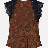 The Pascaline Floral Lace Top by VERONICA BEARD features a brown floral print, short black lace sleeves, and delicate lace trim, seen here from the back. Its tailored fit and subtle sheen accentuate the intricate floral motif across the fabric, offering an elegant and sophisticated look.