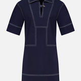 The VERONICA BEARD Phelix Topstitched Mini Dress is a navy stretch-cotton poplin mini dress with white contrast stitching, wide collar, V-neckline with button closure, relaxed sleeves, and geometric front panel detailing.
