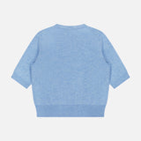 The Shana Cropped Cashmere Sweater by VERONICA BEARD is displayed flat on a white background, viewed from the back. This light blue, short-sleeve knit sweater features a relaxed fit with a round neckline and ribbed trim along the hem, sleeves, and collar. The design is clean and minimalist with no visible patterns or embellishments.