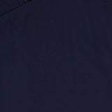 Close-up of the Shanice Scalloped Lace Hem Dress by VERONICA BEARD, featuring smooth, dark navy blue fabric with a visible seam and partial zipper at the top left corner. The sleeveless mini dress has a uniformly colored texture.