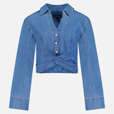 The Timothy Twist Detail Shirt by VERONICA BEARD is a long-sleeve, light blue cropped denim shirt with a collared neckline, button-down front, and twist waist detail, shown on a plain white background.