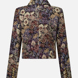 Back view of the Veronica Beard Wilde Brocade Jacket with Removable Collar, an Italian floral brocade cropped long-sleeve jacket in a dark, multi-colored print with a notched collar and gold buttons on the cuffs.